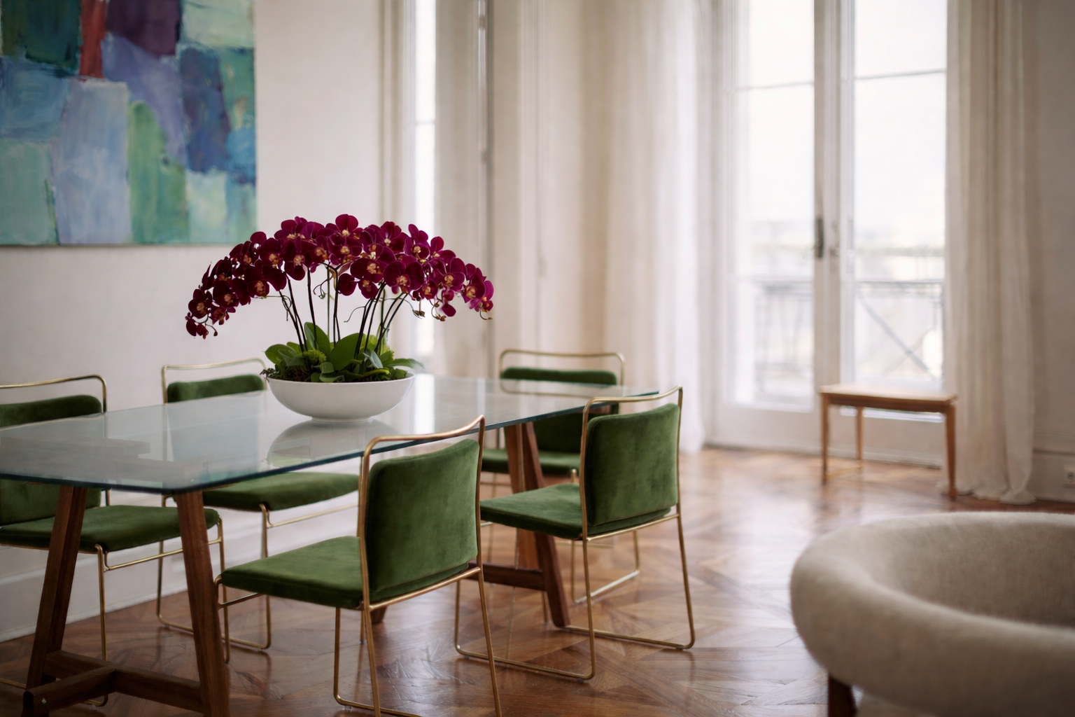 Dining room with a table, chairs, and a vase of purple flowers.