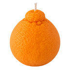 An orange-shaped novelty candle with a textured orange peel surface and a white wick on top, isolated on a solid black background.