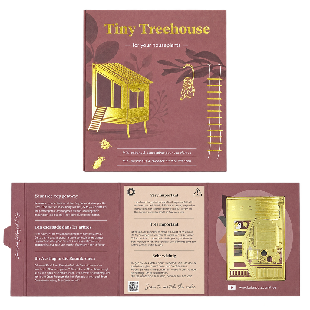 The product packaging for the 'Tiny Treehouse' houseplant accessory kit, shown in both its front cover and unfolded instruction booklet layout. The color scheme is a dusty rose/muted pink with metallic gold foil illustrations of a treehouse, ladder, and monkey, alongside German text instructions.