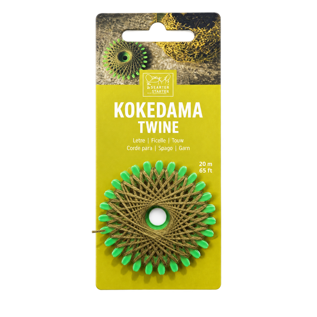 A package of Kokedama Twine by Starter Studios, featuring a roll of tan twine wrapped into a circular kokedama web with bright green tips, mounted on a yellow cardboard backing.